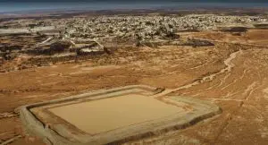 A new water harvesting structure in Azraq water basin of Jordan, made from surrounding mud, is seamlessly integrated into its environment.